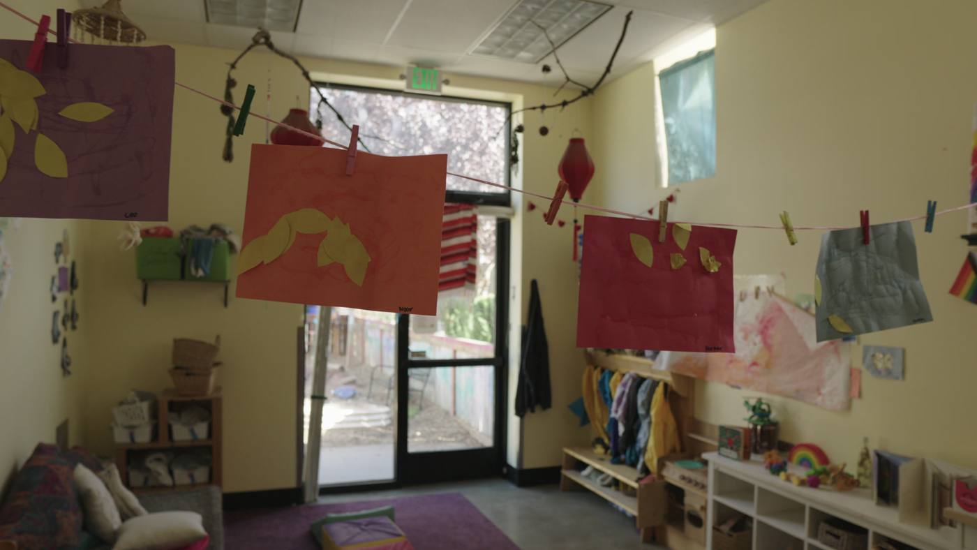 Children's art hanging in a classroom window at a Portland school